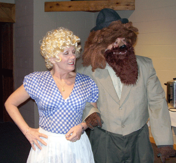 Arlene Merryman as Dorothy is suckered into buying blank maps to the Emeril City from Gino Angelo as the Italian Cowering Lion. He tells her if she wants maps with printing, that's gonna cost her extra.